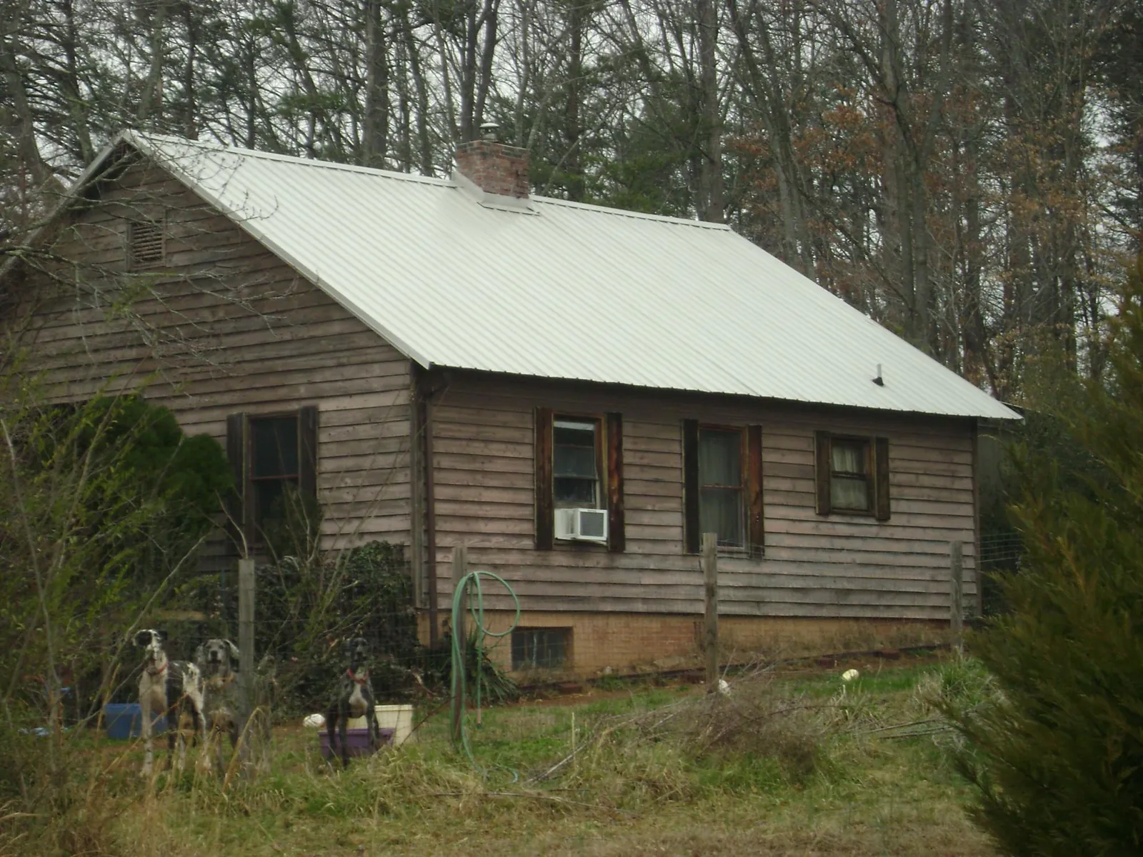 White metal roof on an old wood sided farmhouse, from a Metal Roof Installation job in Stirling